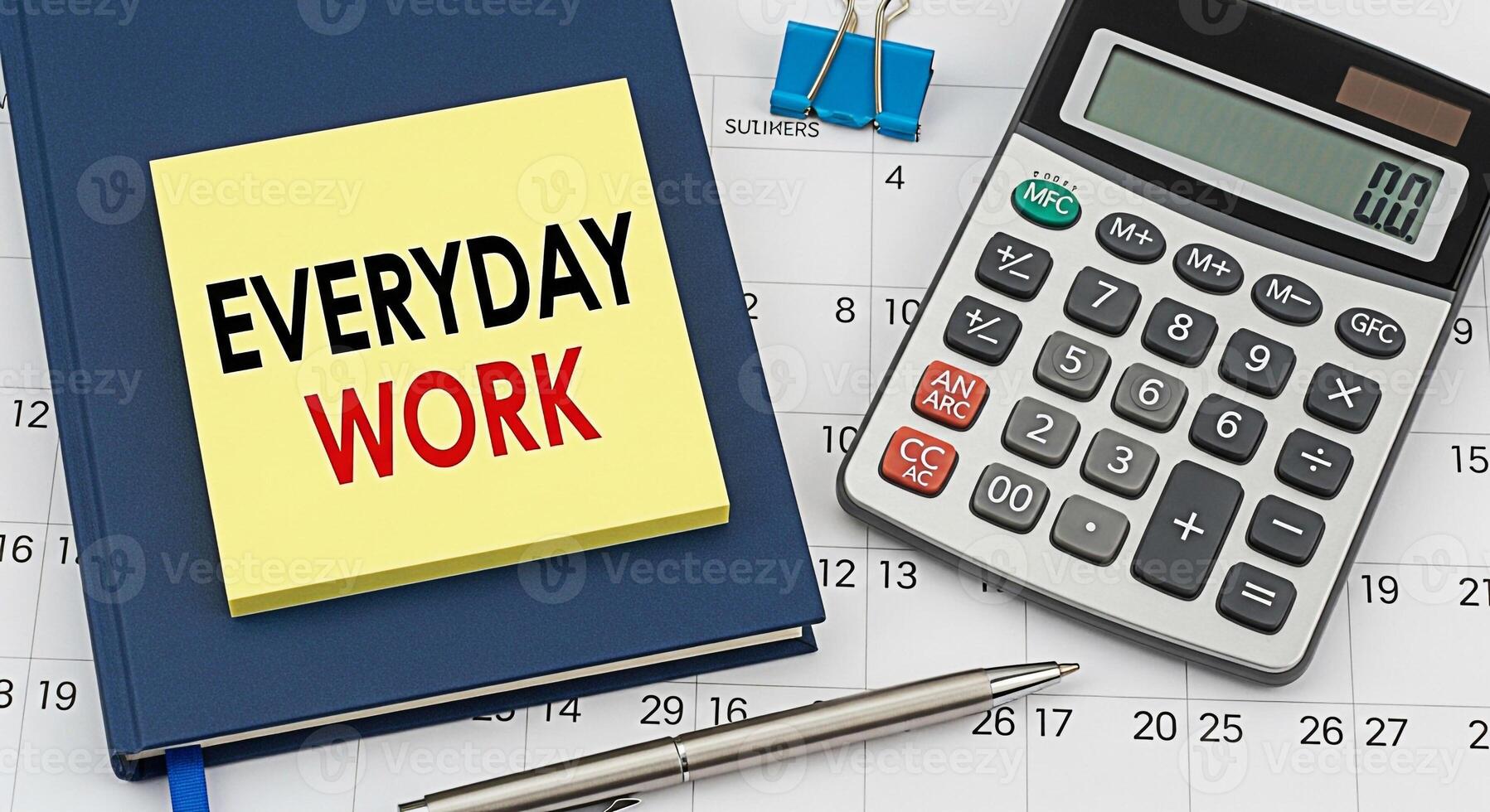 Closeup of everyday work tools on a calendar including a notebook sticky note with the words Everyday Work a calculator and a pen symbolizing routine tasks and time management in a business setting photo
