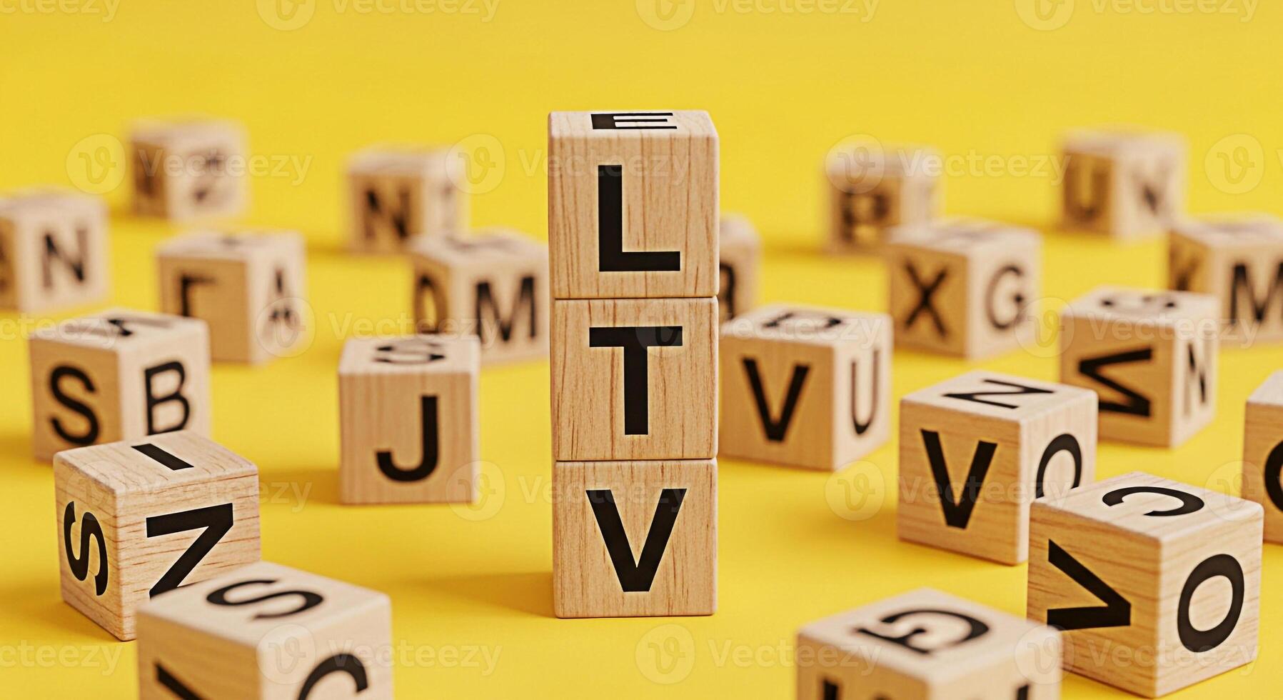 Wooden blocks spelling out LTV on a bright yellow background representing the concept of Lifetime Value in a playful and educational setting ideal for illustrating business and marketing strategies wi photo