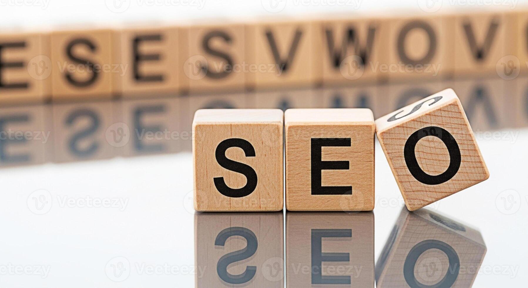 Wooden blocks spelling SEO on a reflective surface representing search engine optimization strategies and digital marketing techniques for improved online visibility and website ranking success convey photo