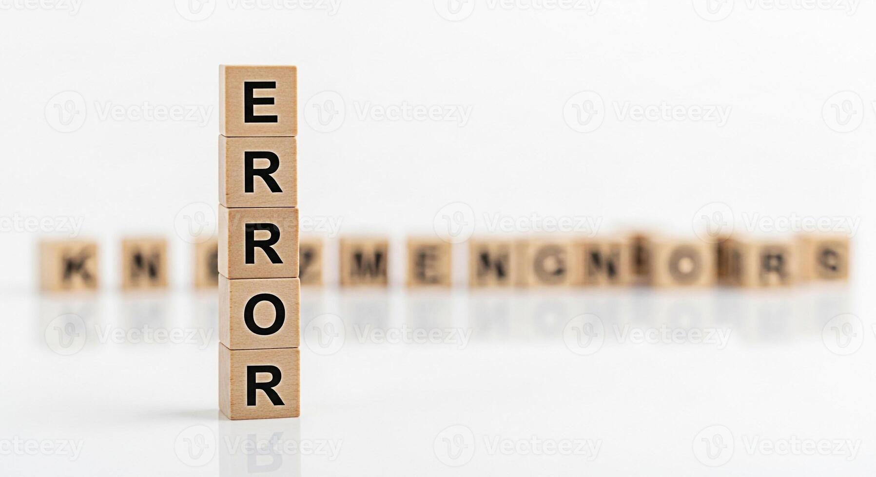 Tower of wooden blocks spelling ERROR standing prominently on a white surface symbolizing failure and mistakes in business technology or personal life conveying a sense of challenge and the need for p photo