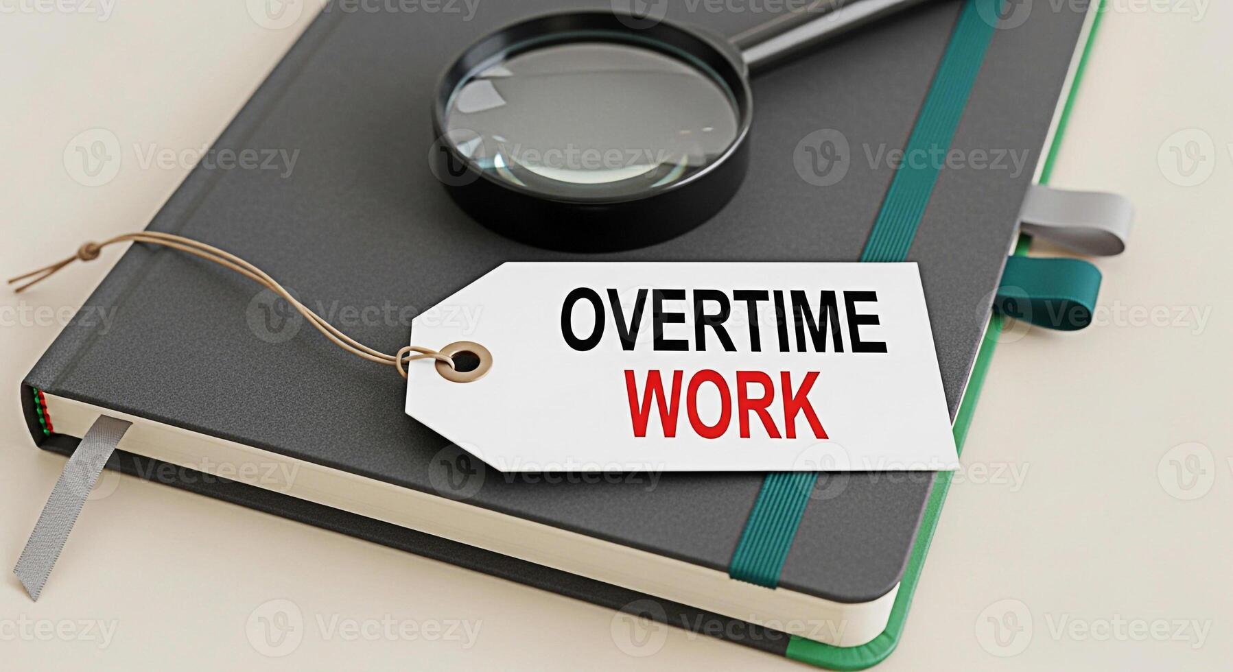 Closeup of a notebook with a tag that reads Overtime Work and a magnifying glass symbolizing the need for careful examination and extra effort in a professional setting creating a mood of diligence an photo