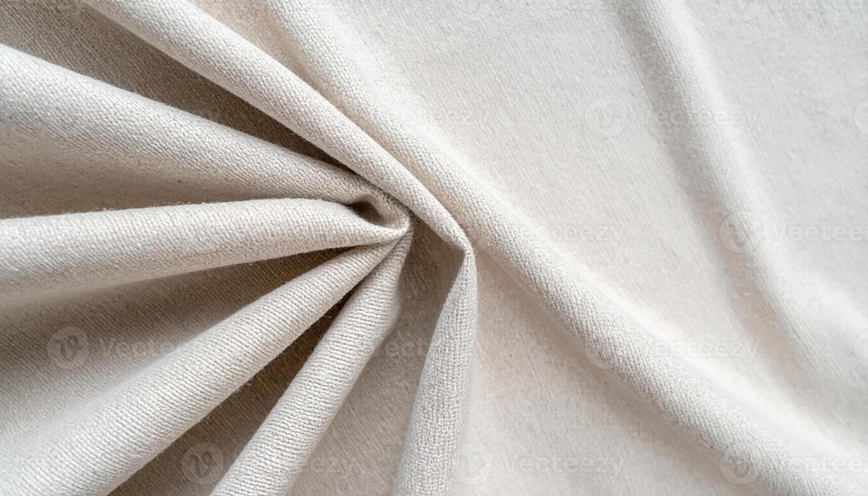 Close up view of a soft beige colored knitted fabric with interesting folds and textures creates a warm and inviting background element. photo