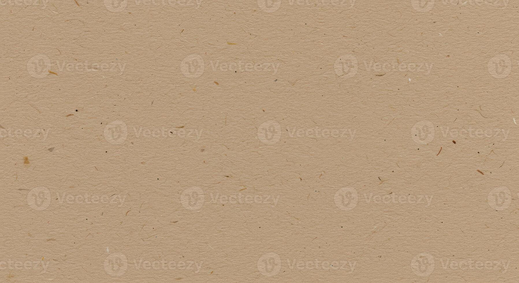 A textured beige surface showcases delicate fibers embedded within, creating a natural and subtly patterned background, ideal for various designs. photo