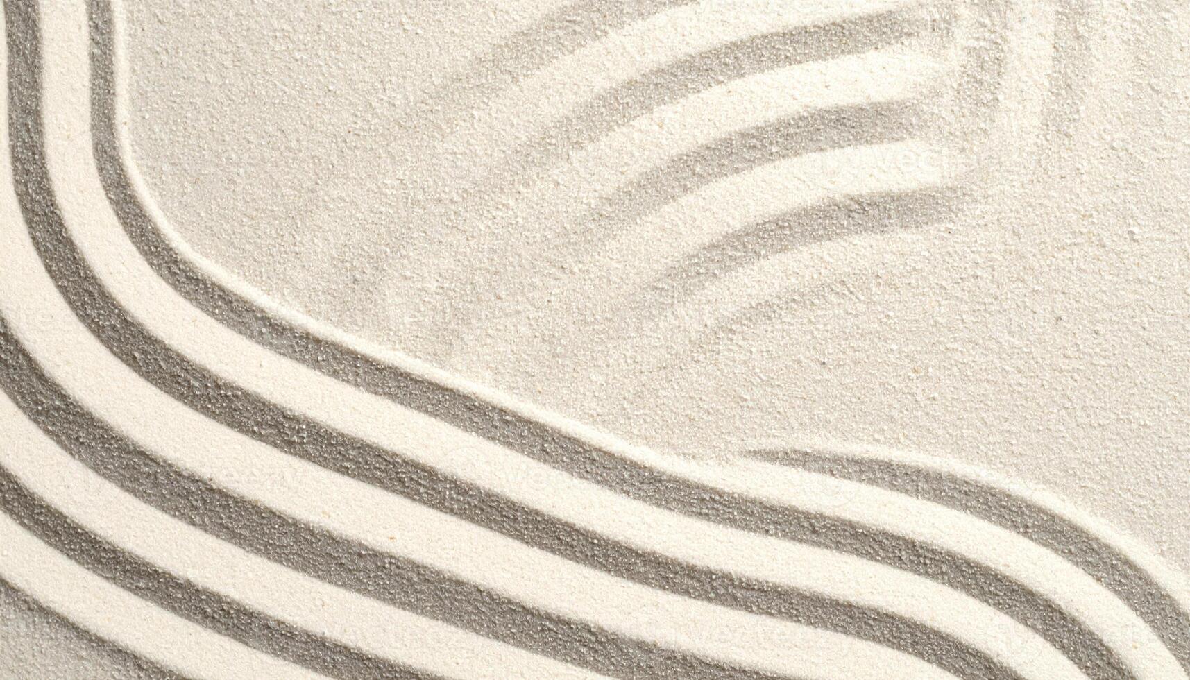 Subtle curves and patterns gently form a calming zen garden design on a field of pristine white sand creating a tranquil scene with lines. photo