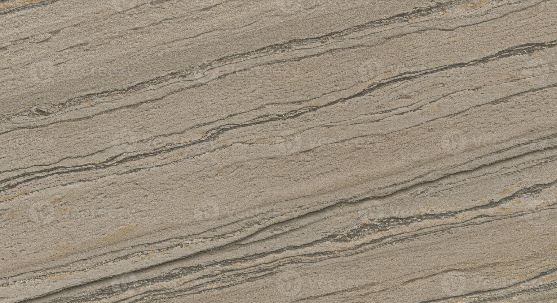 Beige stone surface shows flowing lines, giving the texture a dynamic and organic appearance, with variations in color and pattern seen throughout. photo