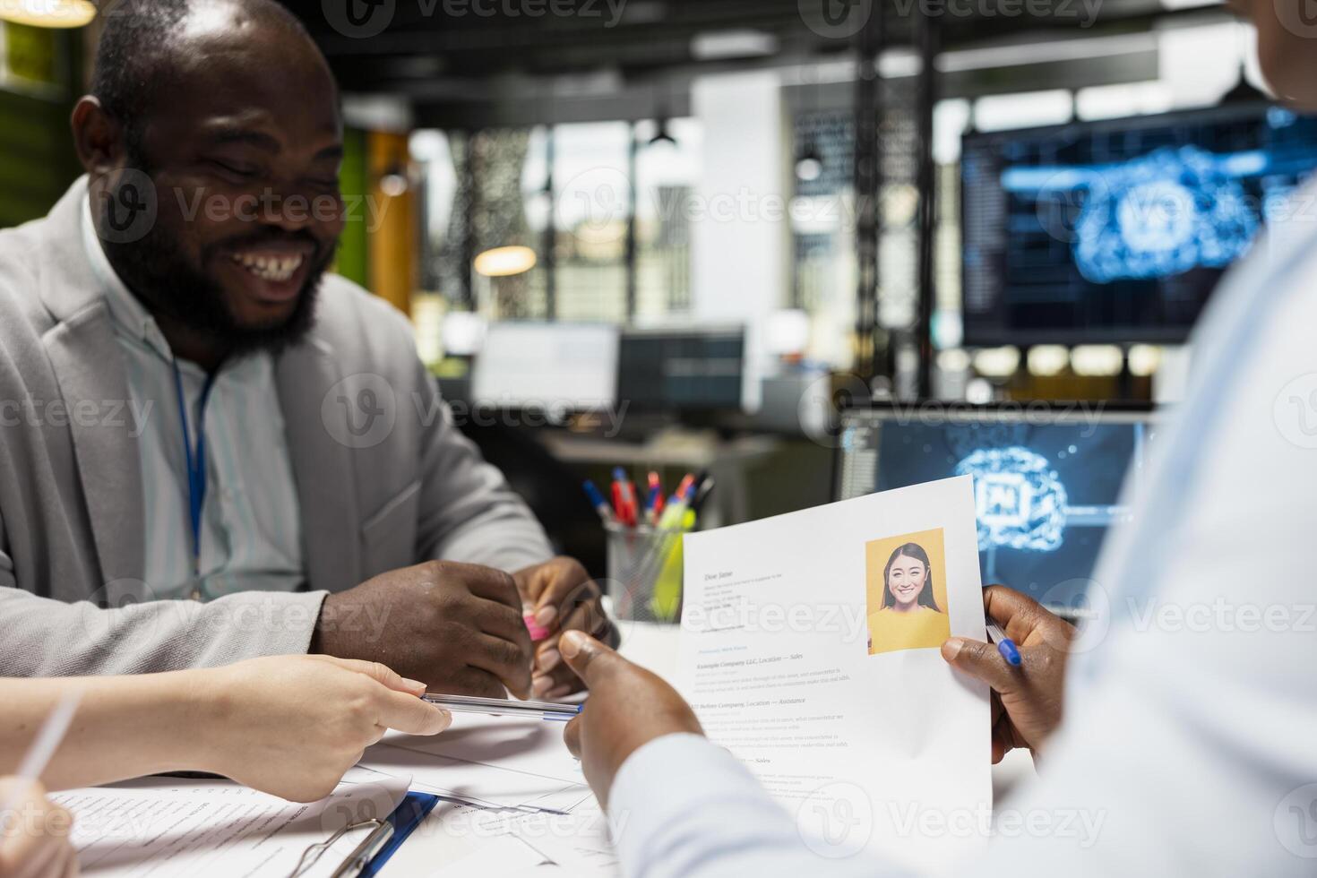 Diverse recruiters using deep learning pc software for profile evaluation, filtering through applicants CV data and helping HR team with decision making. Filling in the company job opening. photo