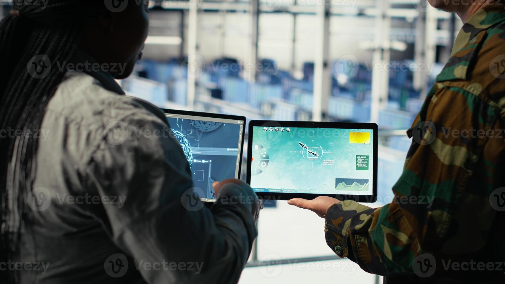 Close up of military data center colleagues looking at radar software to watch for enemy threats. Teamworking army staff members in data center scan suspicious activity to detect dangers, camera B photo