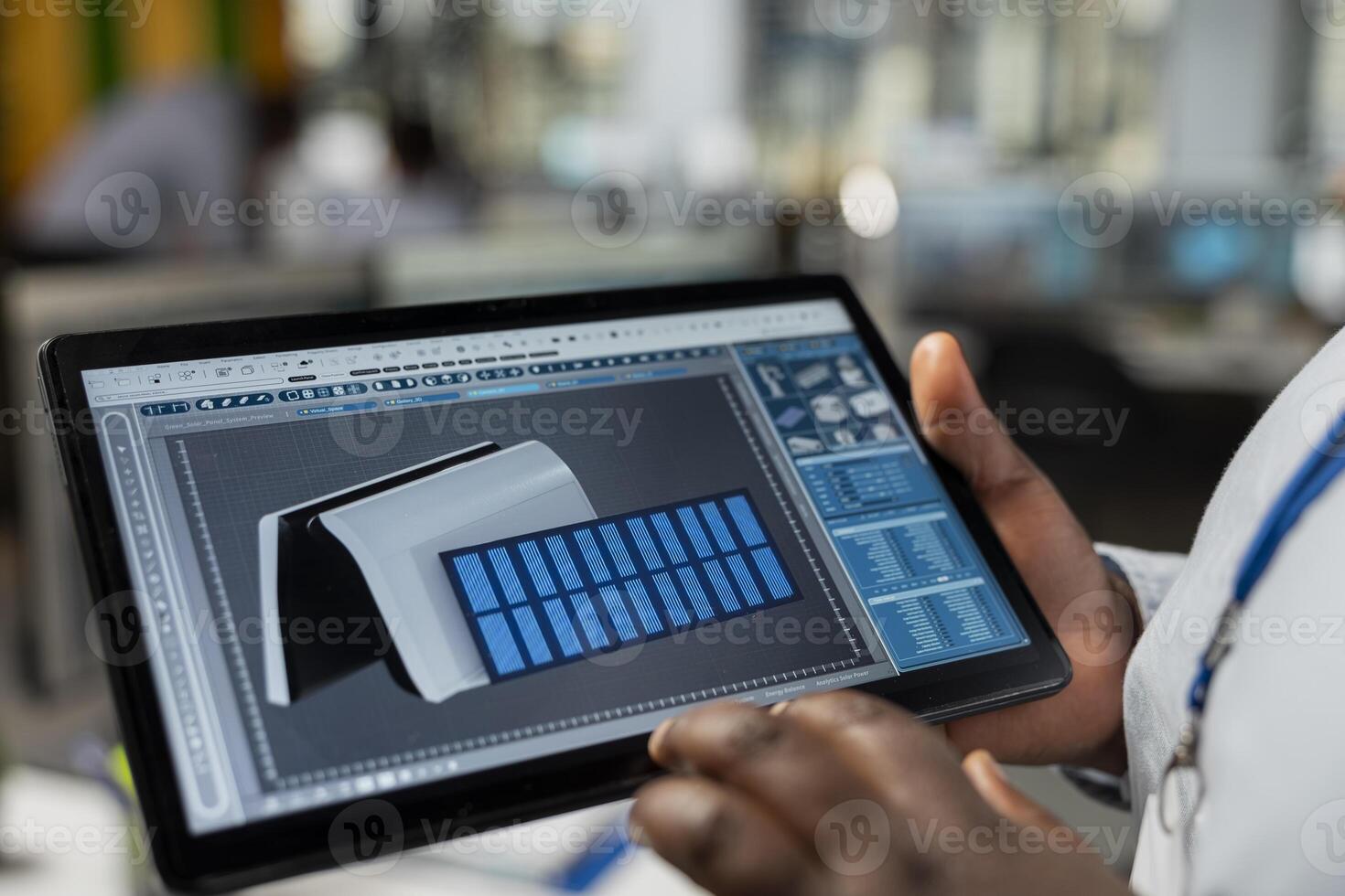 Close up of engineer using CAD app on tablet to optimize sustainable solar cells device fabrication. Clean energy professional innovates solar powered gadget prototype using touchscreen device photo