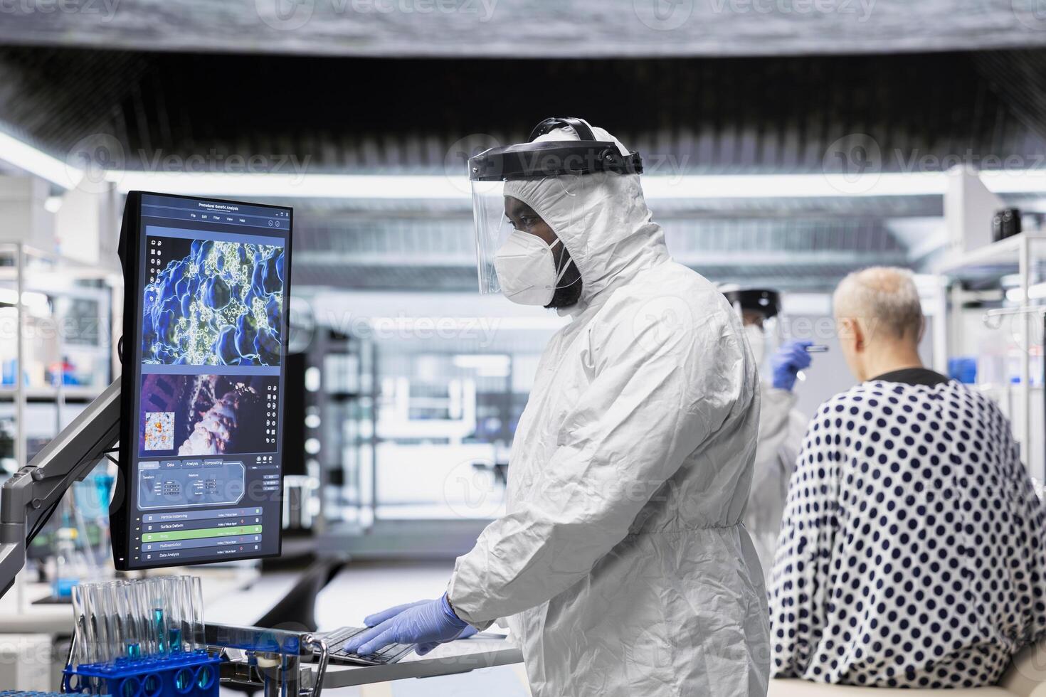 Scientist in hazmat suit checking DNA molecules of infected patient in a bioscience lab, analyzing pathology and virology data, testing immunology theories and developing vaccines. photo