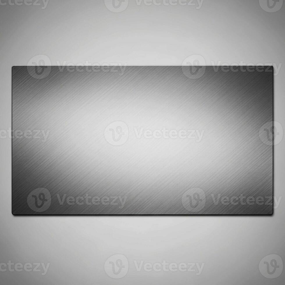 A brushed metal rectangular plaque with subtle lighting creating a soft gradient effect and a textured background photo