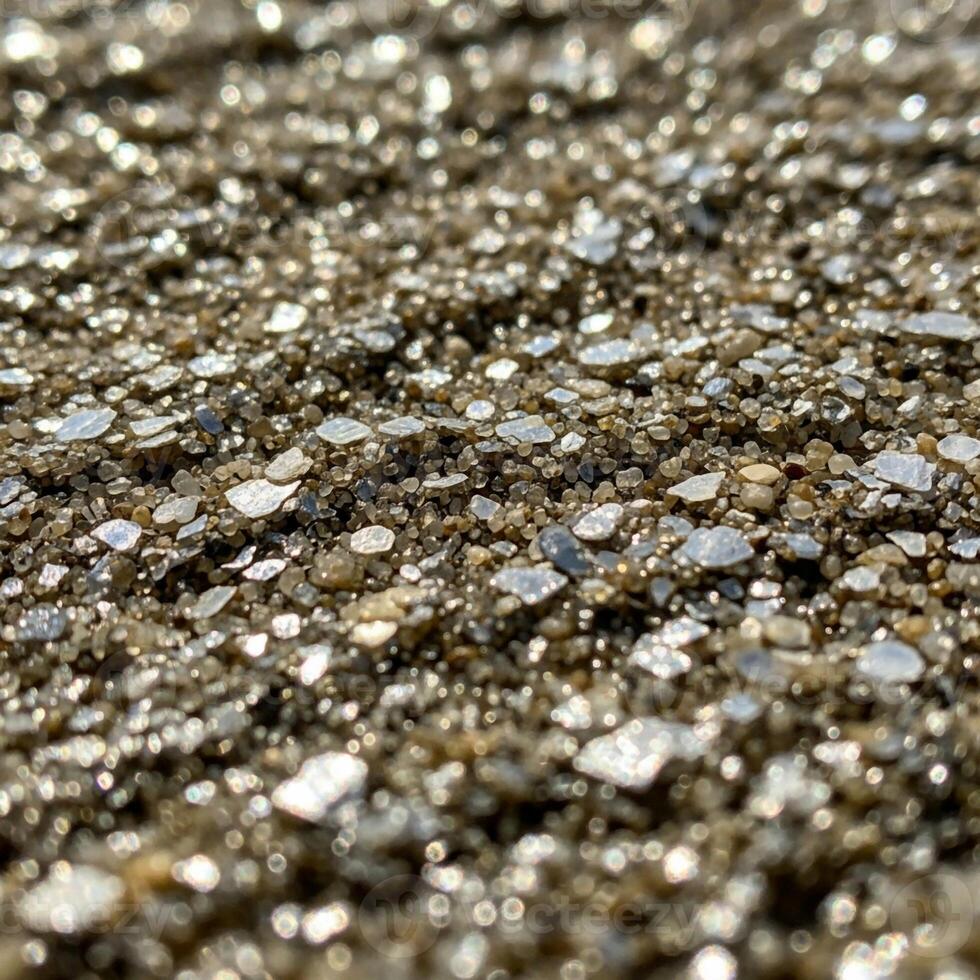 Close up abstract view of shimmering metallic gold and silver glitter particles creating a textured background photo