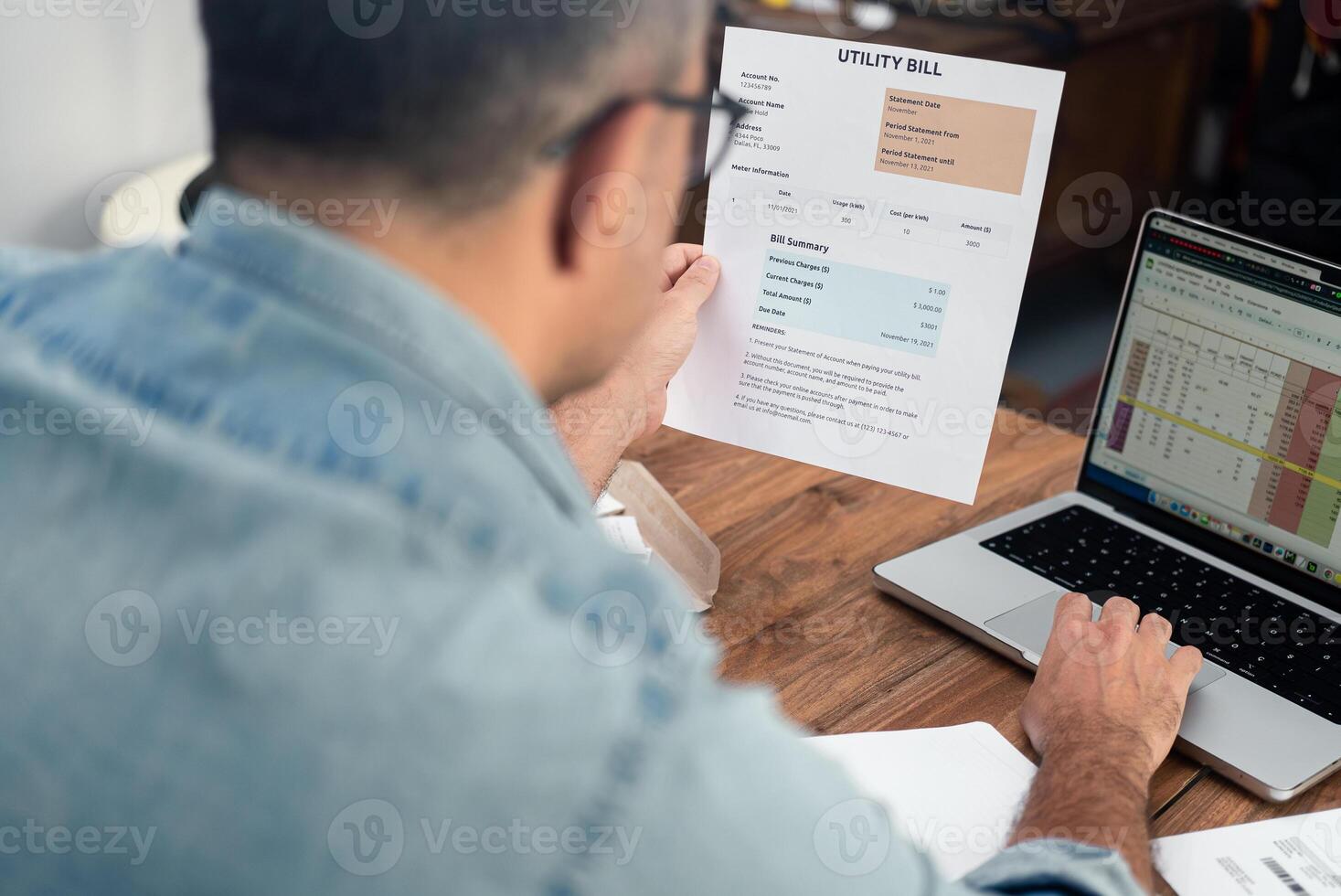 Mature man inputs utility bill data in digital spreadsheet working on computer, old male entrepreneur processes household expense count, regular payments organization photo