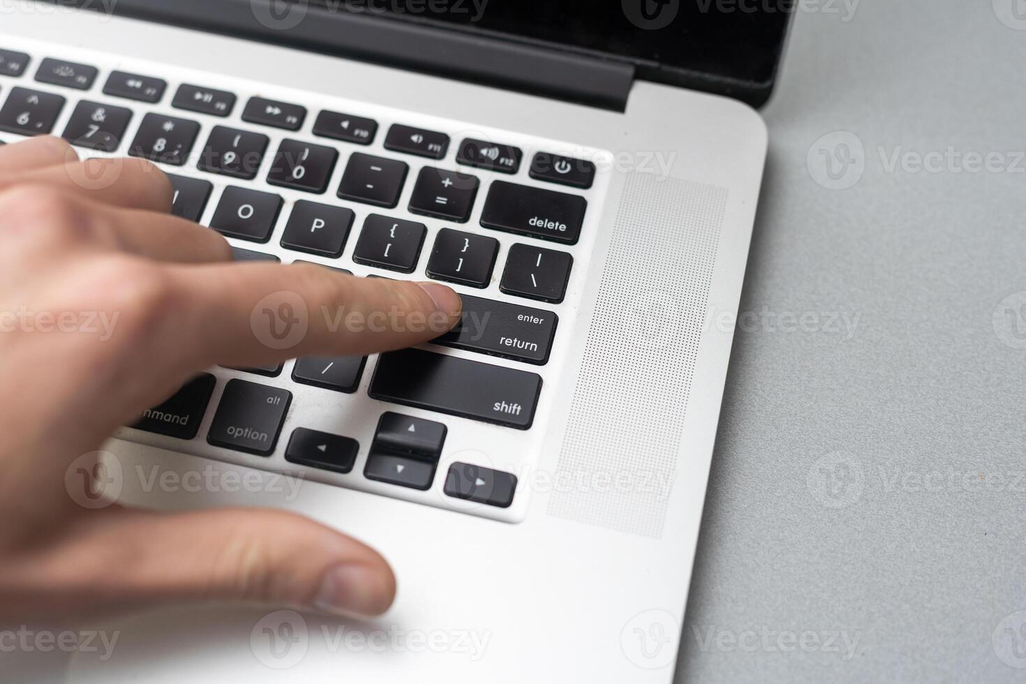 Pressing enter button on the computer keyboard photo