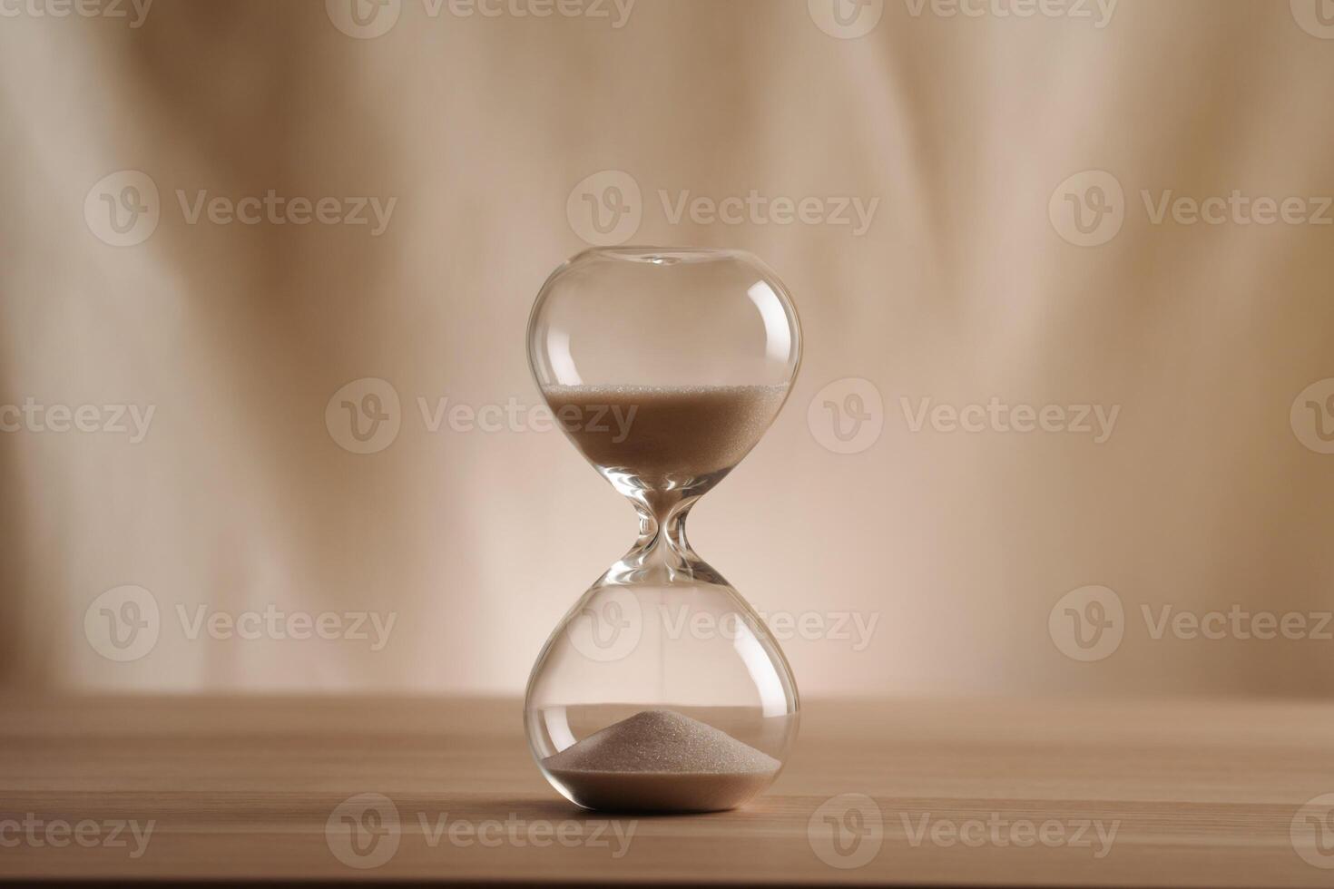 A simple hourglass on a wooden table with a beige backdrop, symbolizing time flow and minimalistic living. Represents timeless themes in a creative, uncluttered presentation for stylish concepts u photo