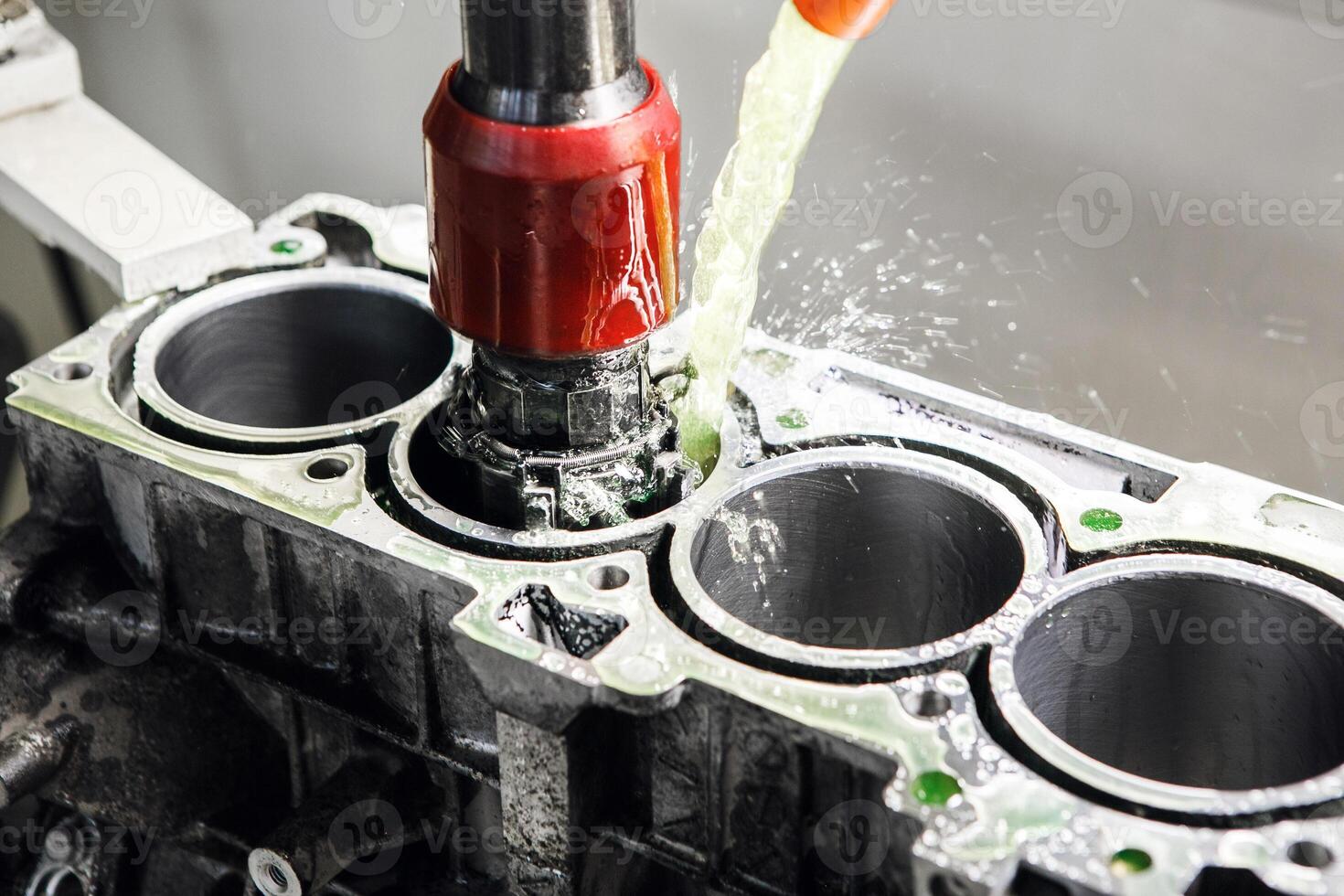 Honing of engine cylinder on CNC Vertical Machine, close up. Car workshop, tuning and repair of engine power. Overhaul of the engine. Machine with ideal bore finish. photo