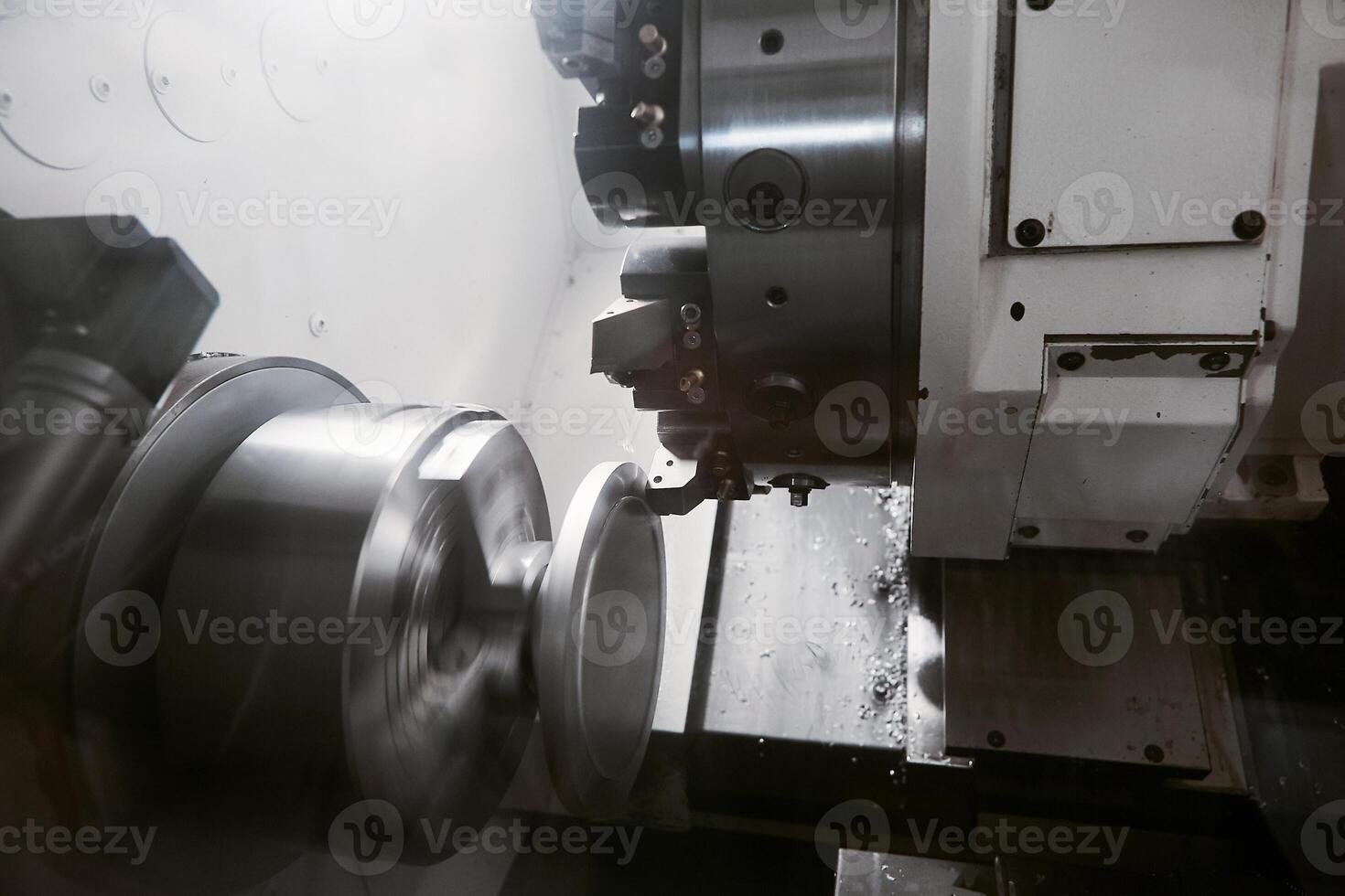 Rotation of aluminium part on CNC metalworking machinery. Working of milling machine with Control Numerical Computer. photo