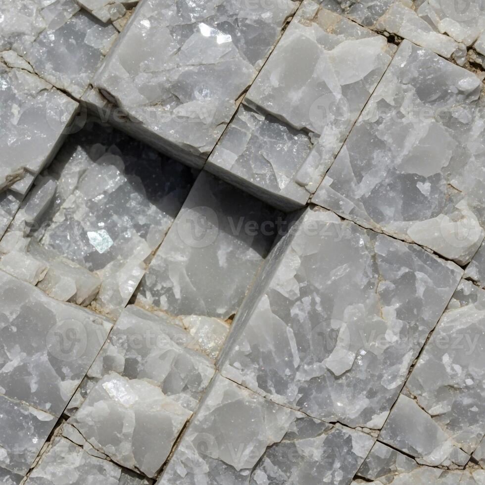 Close up view of fractured gray rock with distinct geometric patterns and subtle variations in texture and shading photo