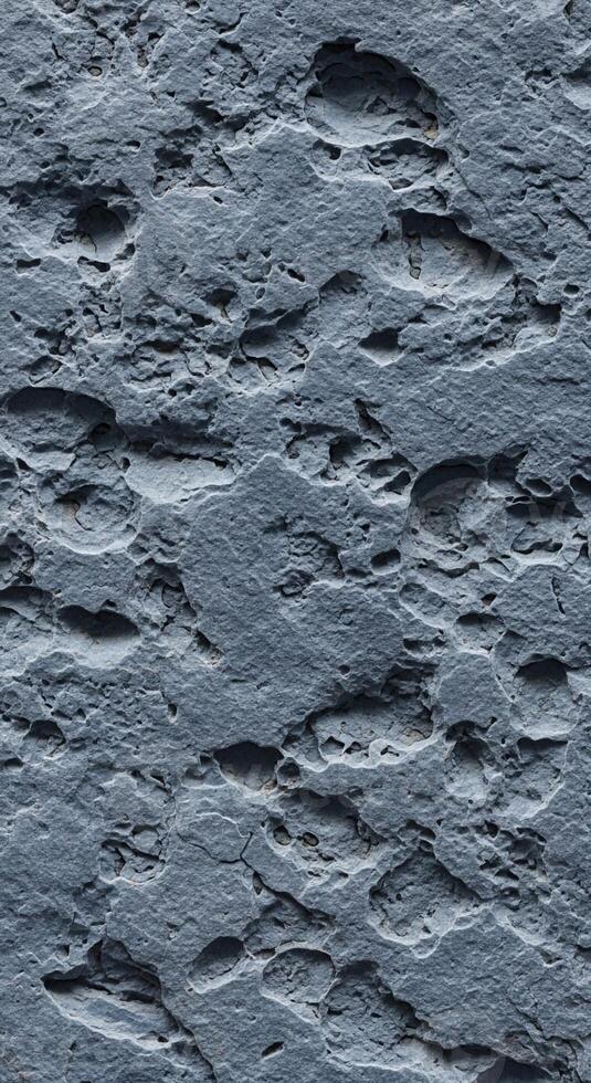 Close up textured surface of weathered dark grey slate stone with rough natural patterns and subtle variations in color photo