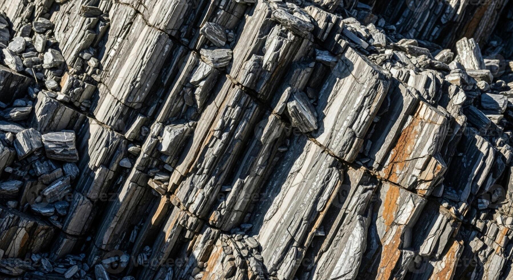 Close up view of weathered columnar basalt rock formations showing distinct vertical columns and varied textures photo