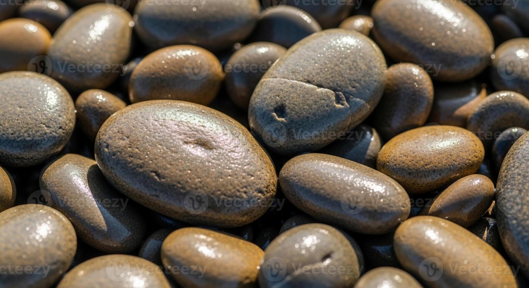 Smooth polished river stones with varied textures and natural earthy tones create a captivating close up abstract pattern photo