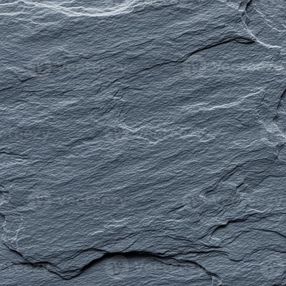 Close up textured surface of dark grey slate stone with natural rough layered patterns and subtle variations photo