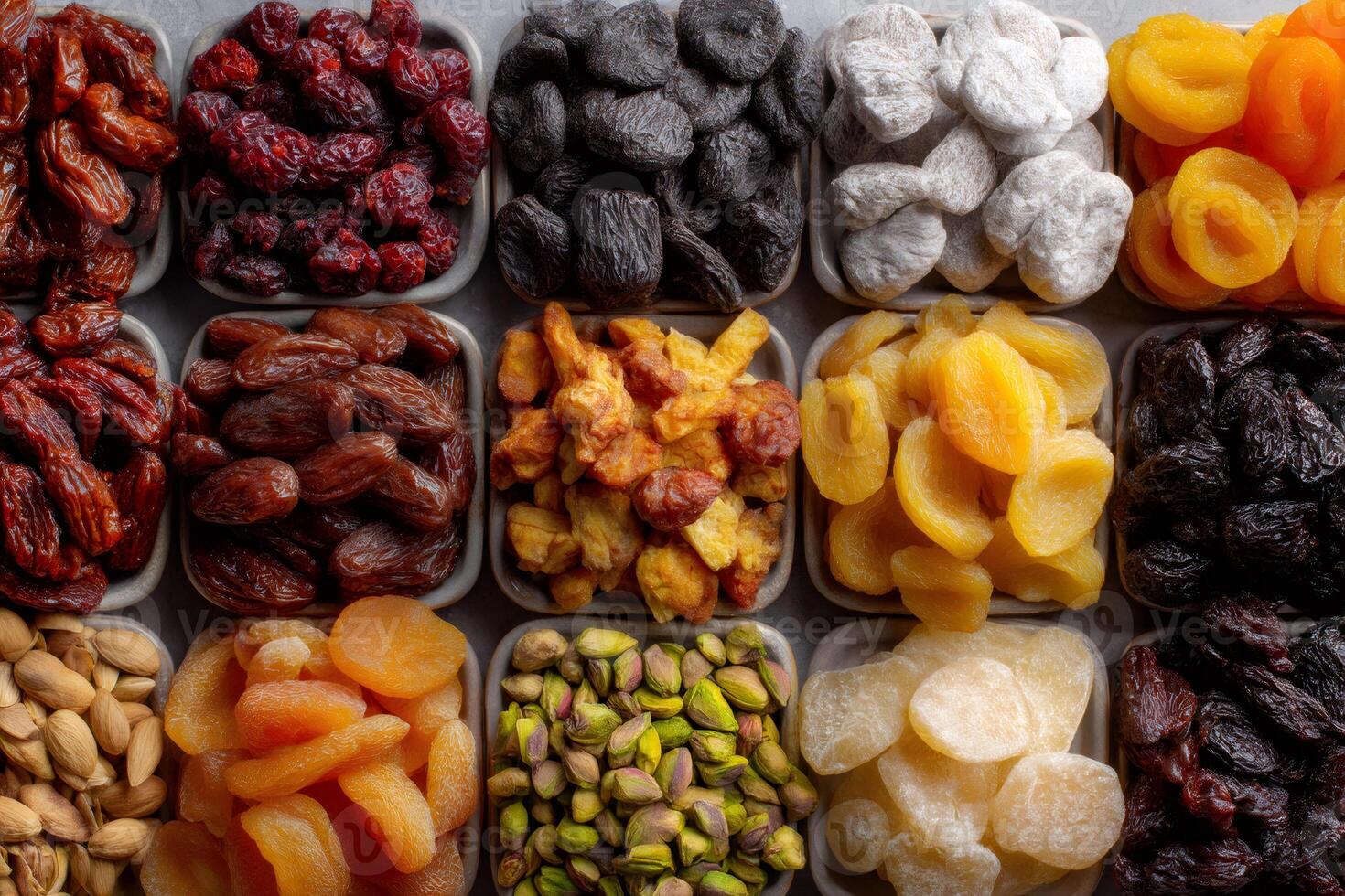Bowls of colorful dried fruits and nuts creating a vibrant and healthy snacking display photo