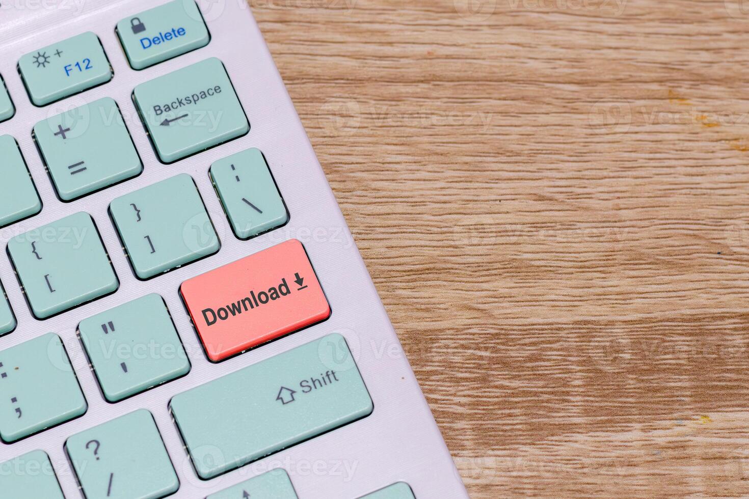 Wireless keyboard with Download button. Keyboard with red download button key. Copy space. photo