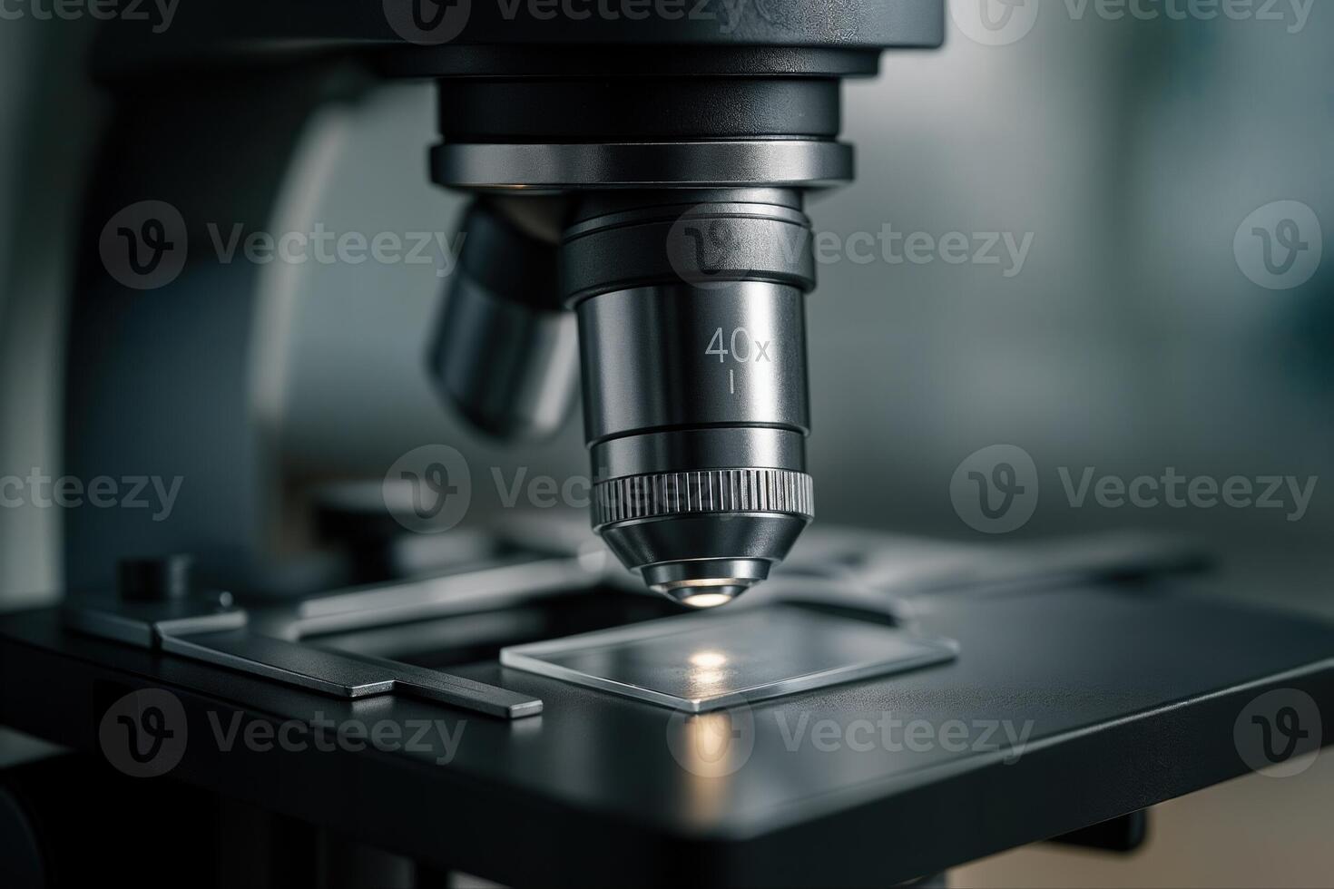 A Closeup View of a Microscope Lens Focused on a Slide in a Science Laboratory With Shallow Depth Of Field Creating a Professional and Clinical Atmosphere photo