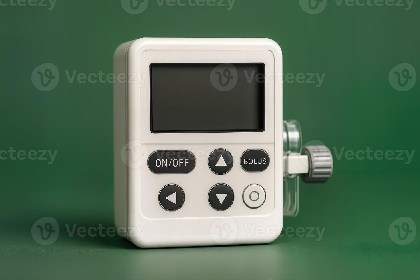 Compact Medical Infusion Pump Displayed on Green Background in a Studio Setting with Its Control Buttons and Display Screen Clearly Visible photo