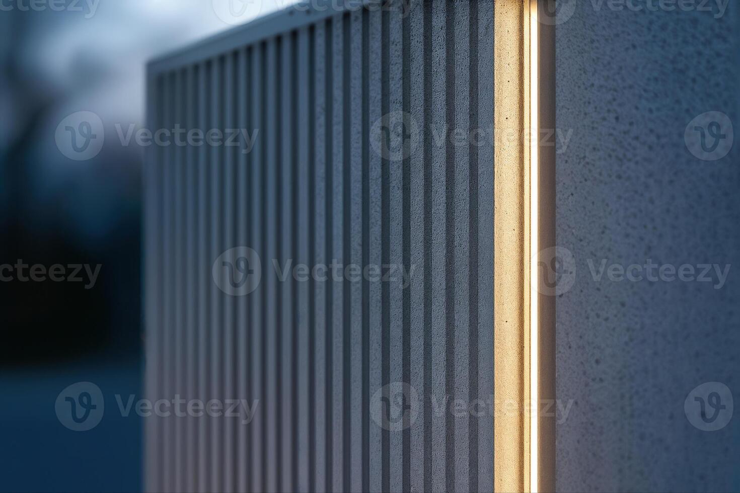 Reeded Concrete Wall Illuminated at Dusk in a Low Light Setting Highlighting Vertical Lines and Texture With Shallow Depth Of Field photo