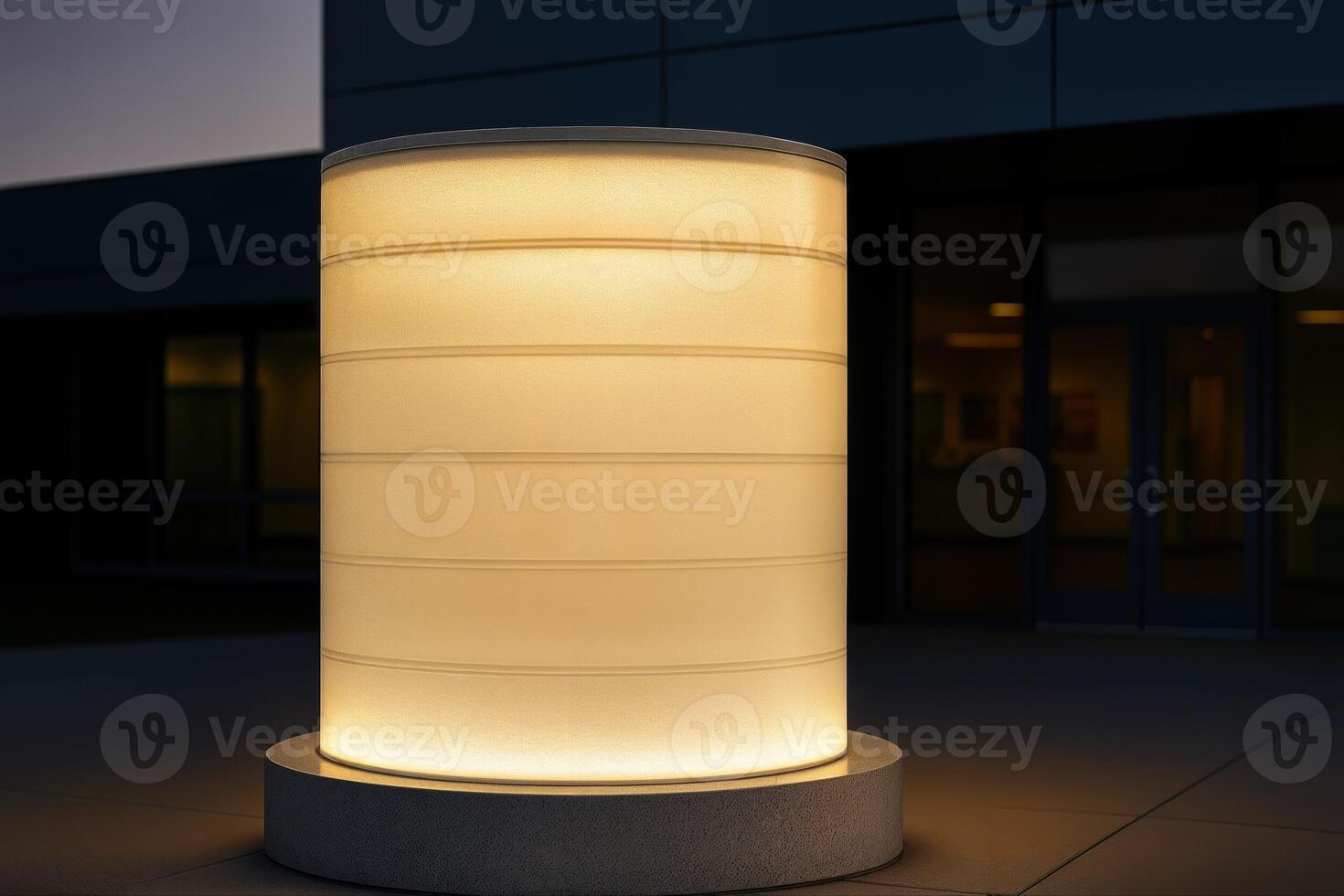 A Glowing Translucent Drum Illuminates the Outdoor Space of a Modern Building at Dusk With Soft Warm Light Creating a Calm and Inviting Atmosphere photo