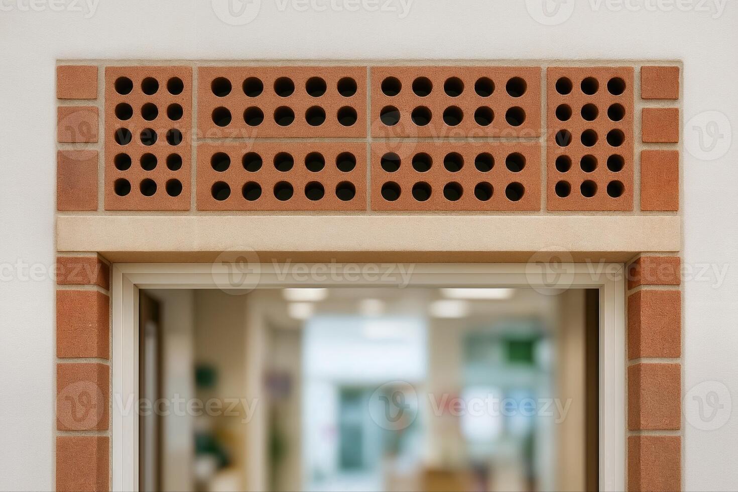 Perforated Brick Ventilator Above Doorway in Indoor Setting with Subdued Lighting and Background With Shallow Depth Of Field photo
