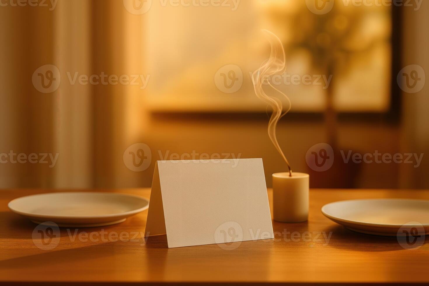 Elegant Dining Ambiance Featuring a Blank Tent Card on a Wooden Table With Plates and a Lit Candle in a Softly Lit Indoor Setting photo