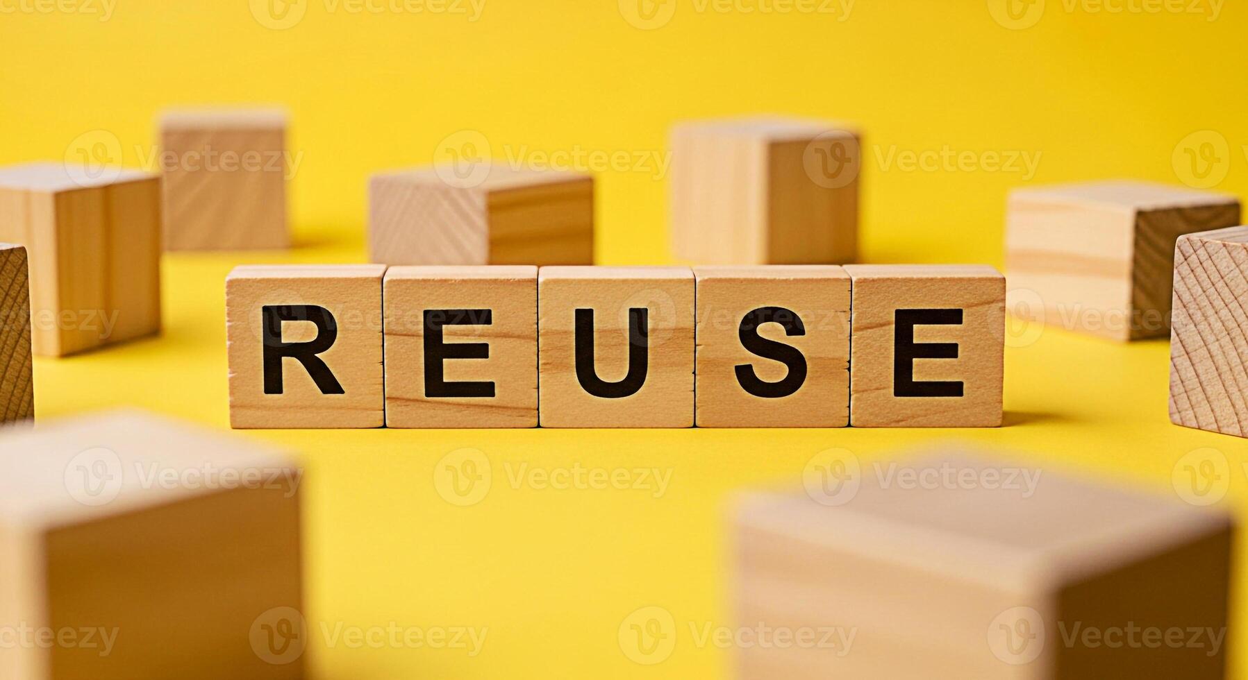 Wooden blocks spelling REUSE on a yellow background promoting sustainability and environmental awareness highlighting the importance of reusing materials to reduce waste and conserve resources in a br photo