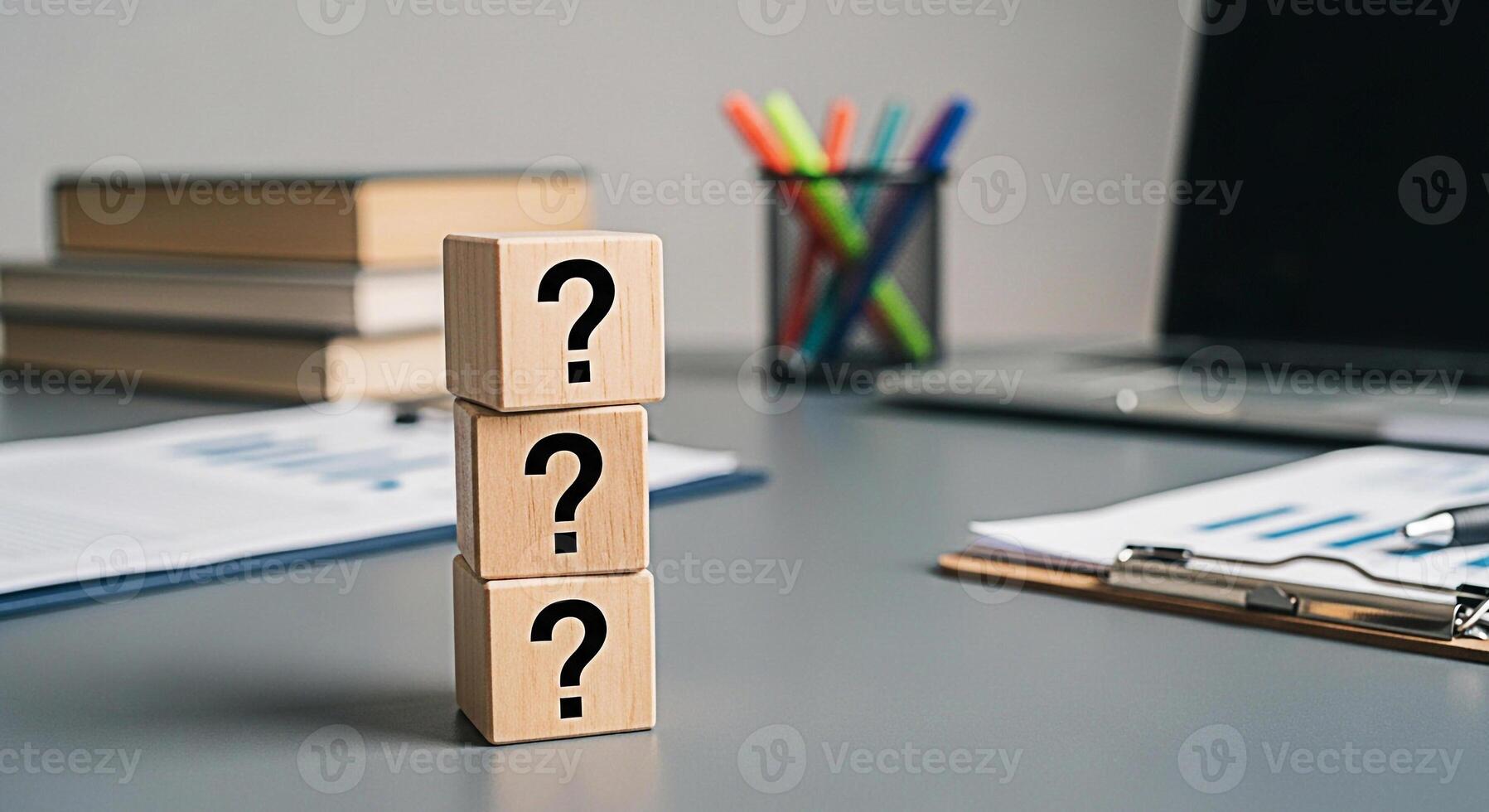 Stacked wooden blocks displaying question marks on a modern office desk representing uncertainty and the search for answers in business strategy and decisionmaking processes fostering a sense of inqui photo