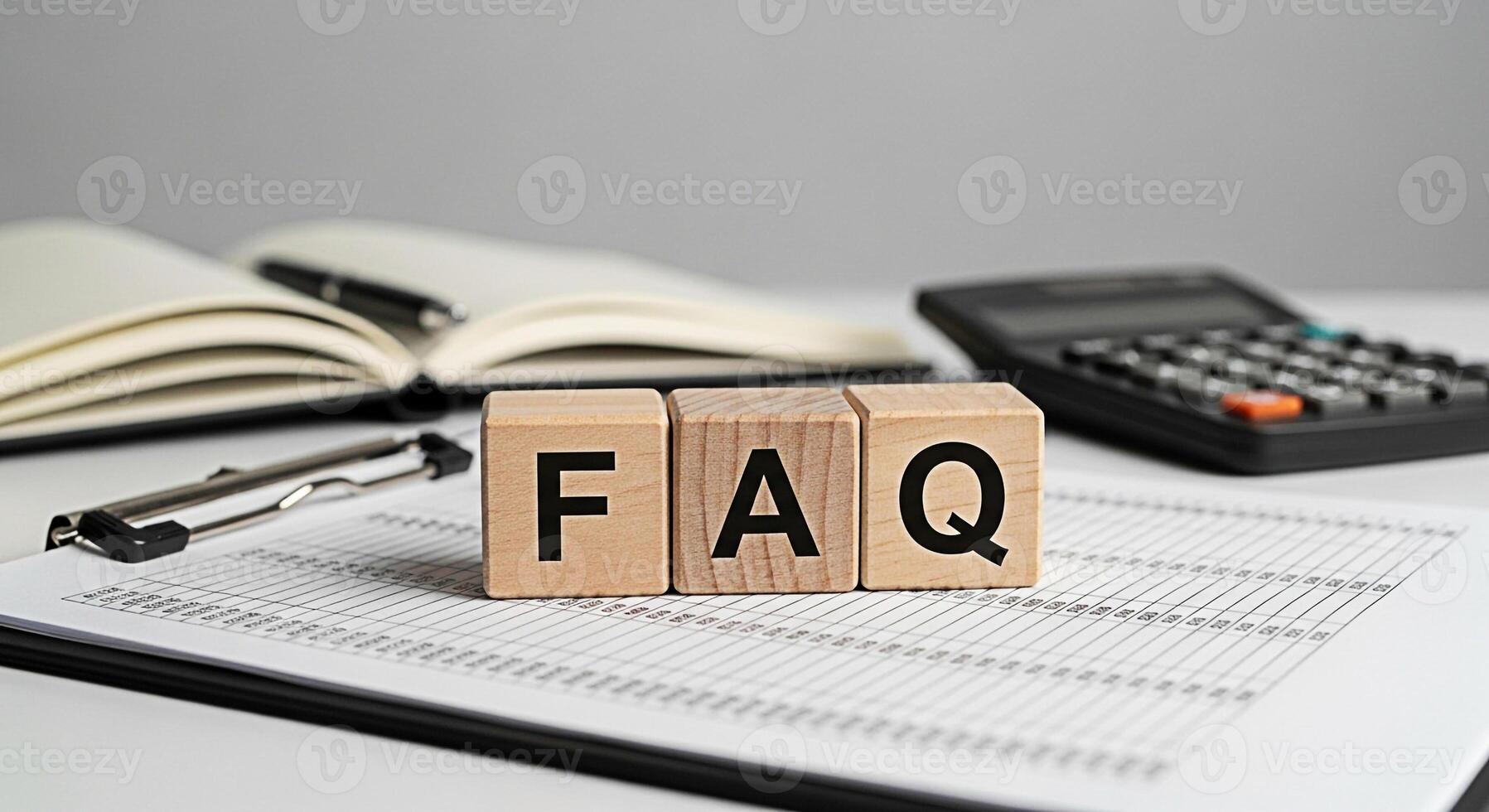 Wooden blocks spelling FAQ on a clipboard in a bright office representing frequently asked questions and information resources for customers and clients promoting clarity and assistance photo