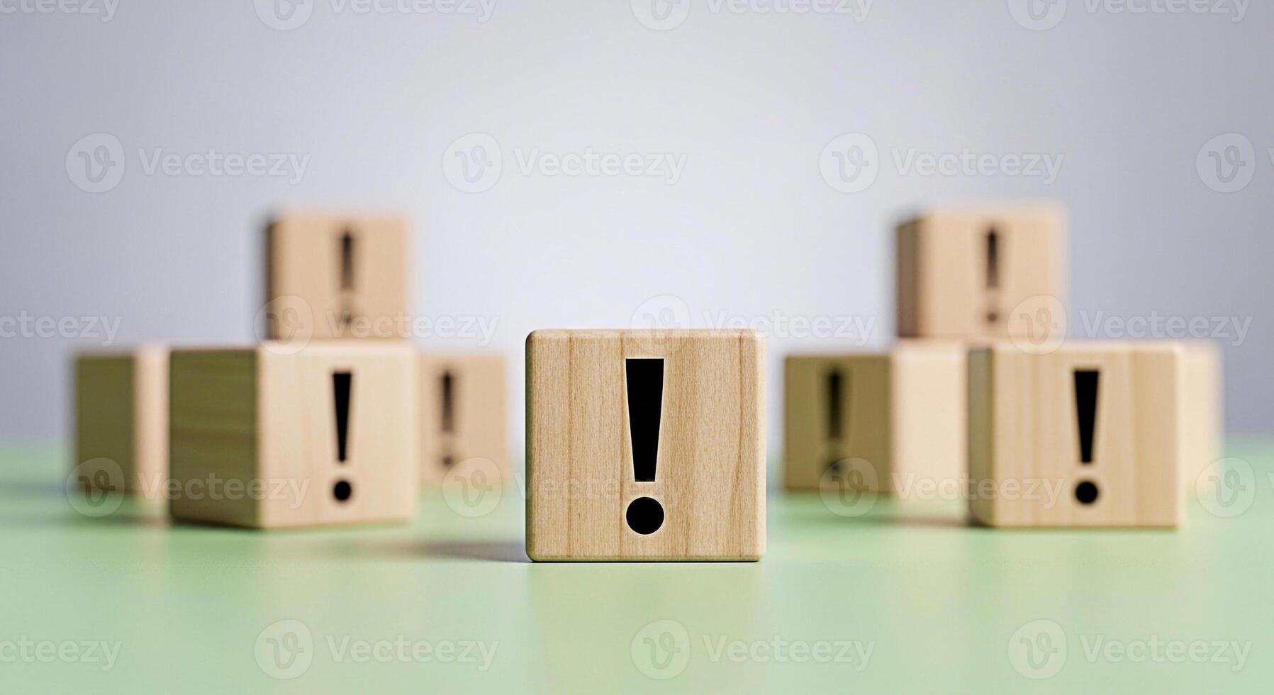 Wooden blocks displaying exclamation marks and blank faces arranged on a neutral surface symbolizing risk assessment and decisionmaking in a business or educational setting conveying a sense of urgenc photo