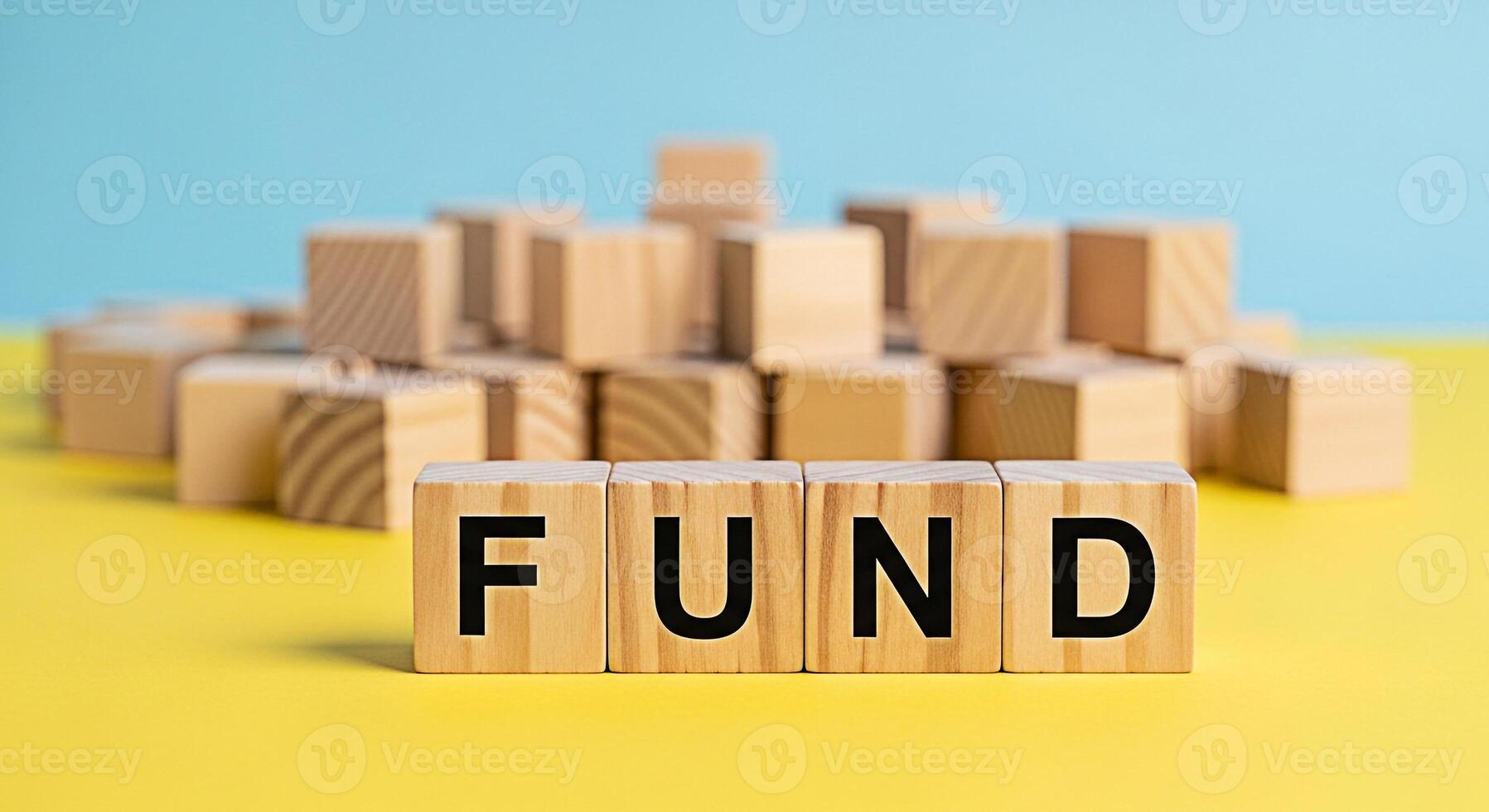 Abstract arrangement of wooden blocks on a yellow surface against a blue background creating a blurred cityscape symbolizing construction development and the potential for growth and building success photo