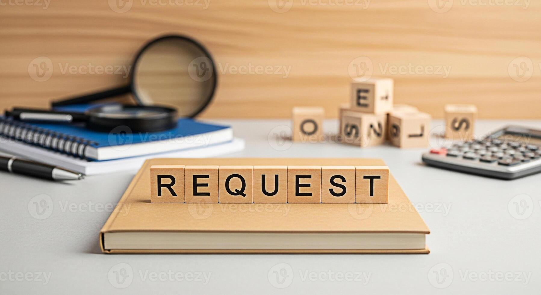 Wooden blocks spelling REQUEST resting on a book in a bright office setting symbolizing a formal inquiry and the need for information or action with a sense of anticipation and expectation photo