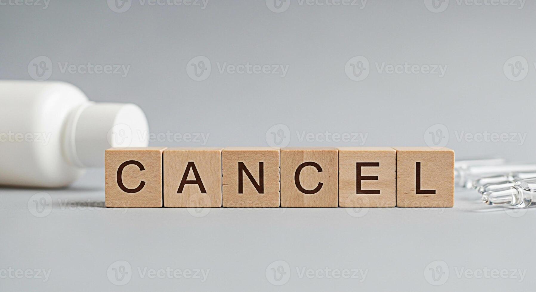 Wooden blocks spelling CANCEL next to medicine bottle and ampules on a gray surface symbolizing the cancellation of treatment negative results or the end of a medical procedure with a sense of finalit photo
