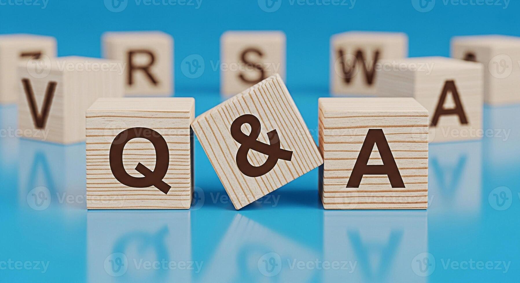 Wooden blocks displaying Q A on a blue reflective surface representing questions and answers in a learning environment creating a mood of curiosity and knowledge acquisition photo