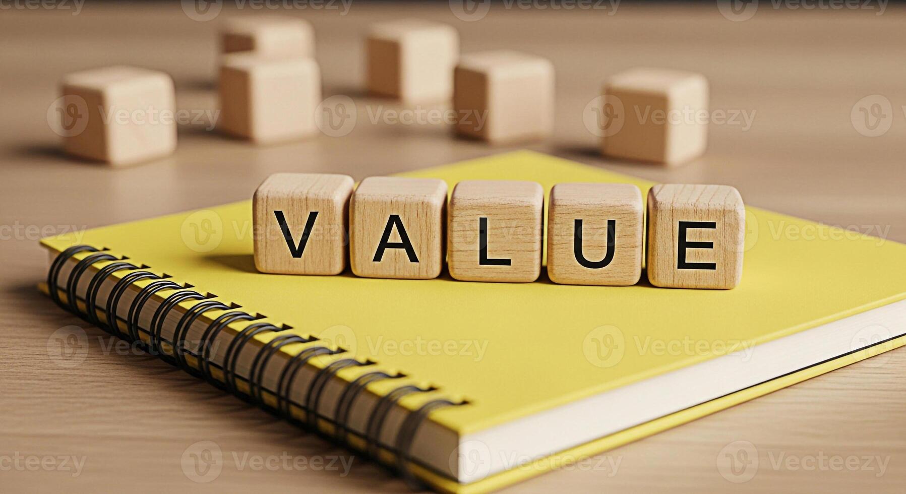 Wooden blocks spelling VALUE resting on a yellow notebook on a wooden desk symbolizing core values business ethics and the importance of integrity in a professional and educational setting photo