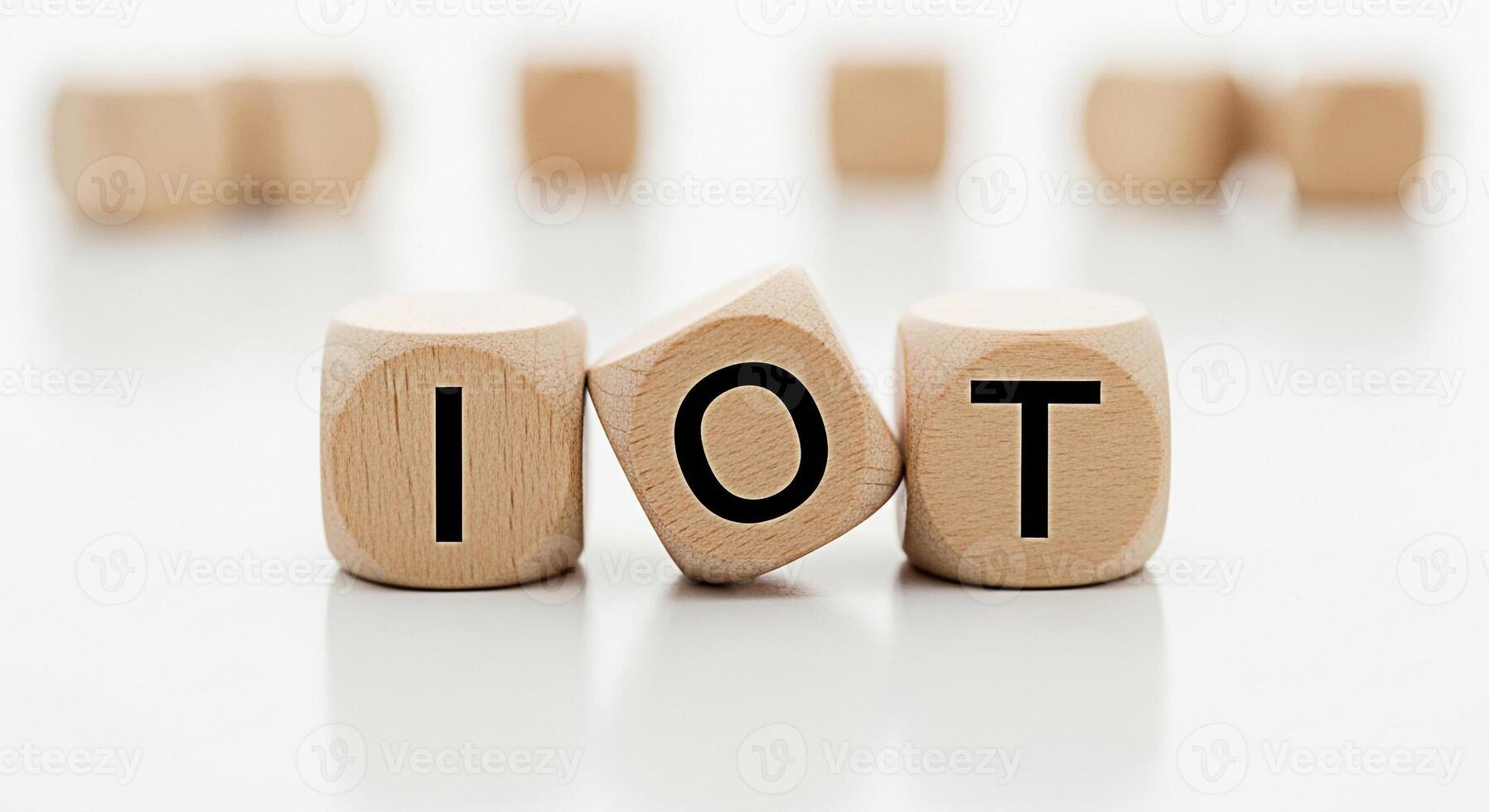 Wooden cubes displaying IOT acronym on a white surface representing the concept of Internet of Things and modern technology conveying a clean and minimalist aesthetic in a studio setting photo