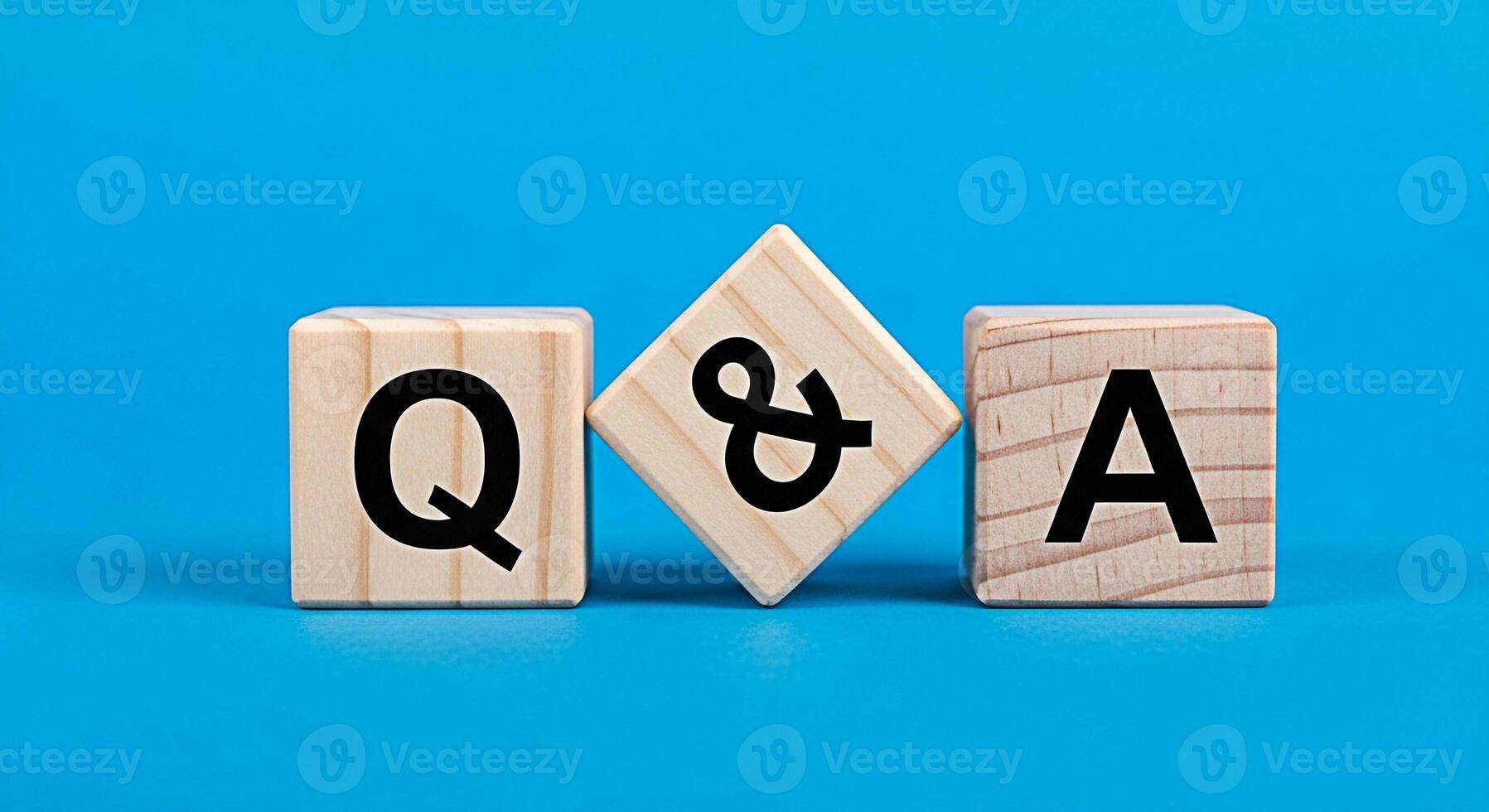 Wooden blocks displaying QA on a vibrant blue background representing knowledge and information ideal for educational content business presentations and customer service resources conveying clarity an photo