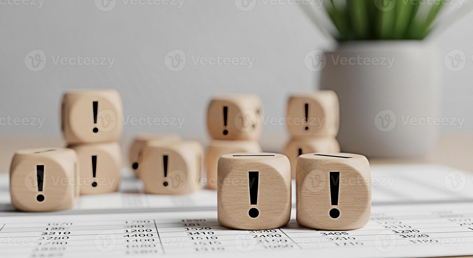 Wooden dice displaying exclamation marks on a financial document in a bright office symbolizing risk assessment problemsolving and the importance of attention to detail in business and finance photo