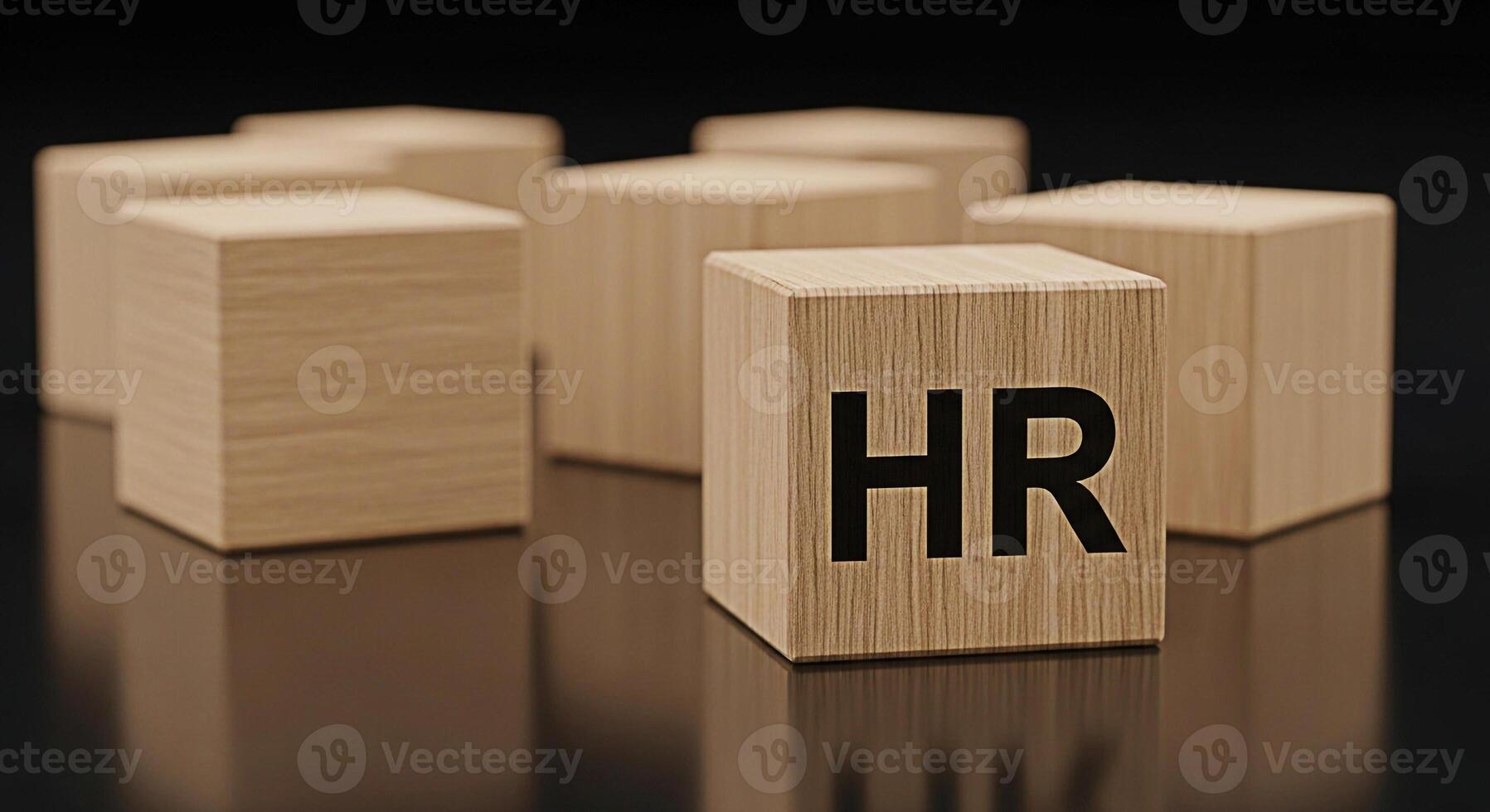 Wooden blocks displaying HR on a reflective black surface representing human resources management and organizational structure with a focus on employee relations and corporate strategy in a minimalist photo