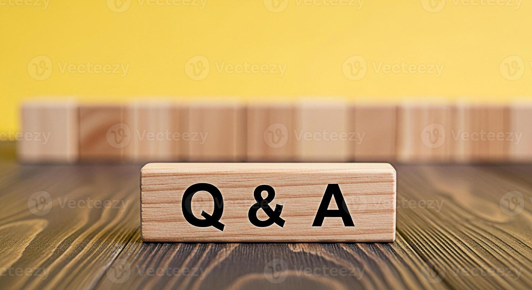 Wooden blocks displaying Q A on a wooden surface with a bright yellow background representing questions and answers knowledge sharing and the importance of information exchange in a clear and concise photo