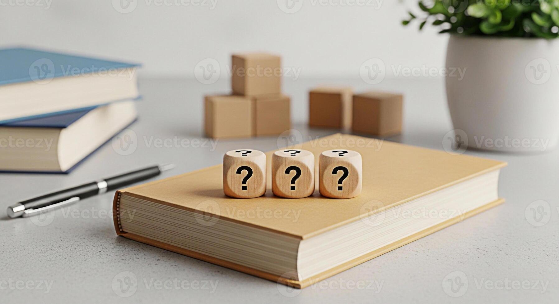 Three wooden dice displaying question marks resting on a tan book in a bright modern office setting symbolizing uncertainty curiosity and the search for answers in business and education photo