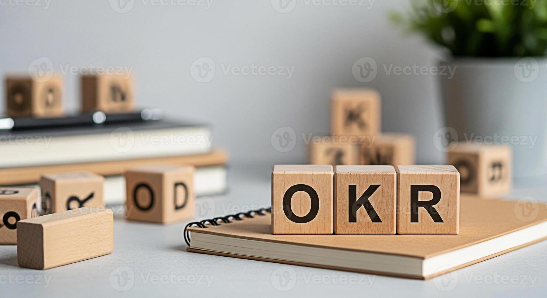 OKR wooden blocks on a notebook in a bright office setting symbolizing Objectives and Key Results promoting a focused and strategic approach to goal setting and achievement in business and project man photo