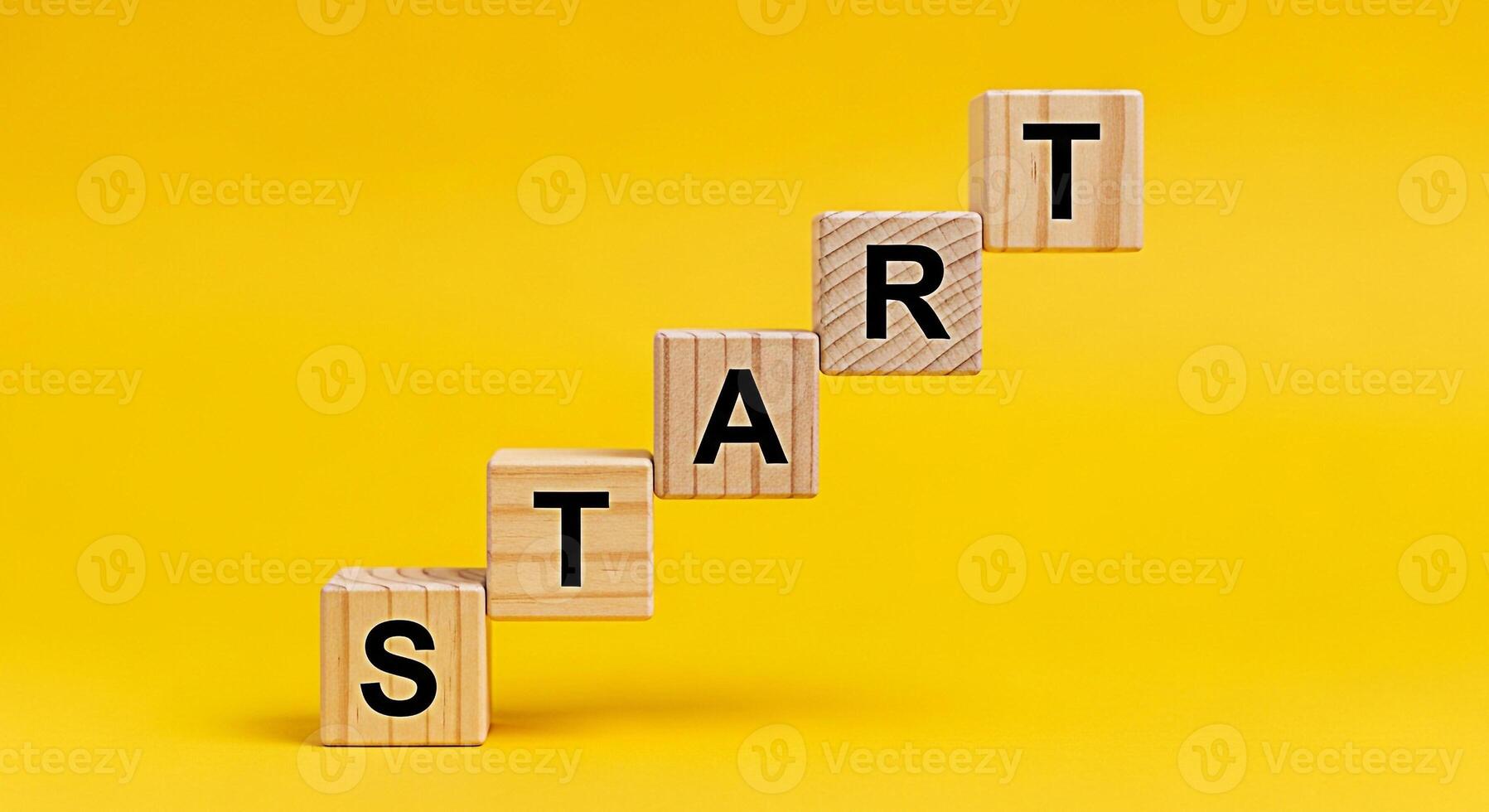 Wooden blocks spelling START arranged as steps on a vibrant yellow background symbolizing a new beginning and the motivation to take the first step towards achieving goals with optimism and determinat photo